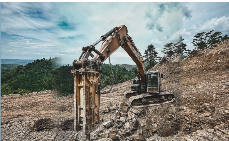 Hydraulic breaker and excavator at a construction site