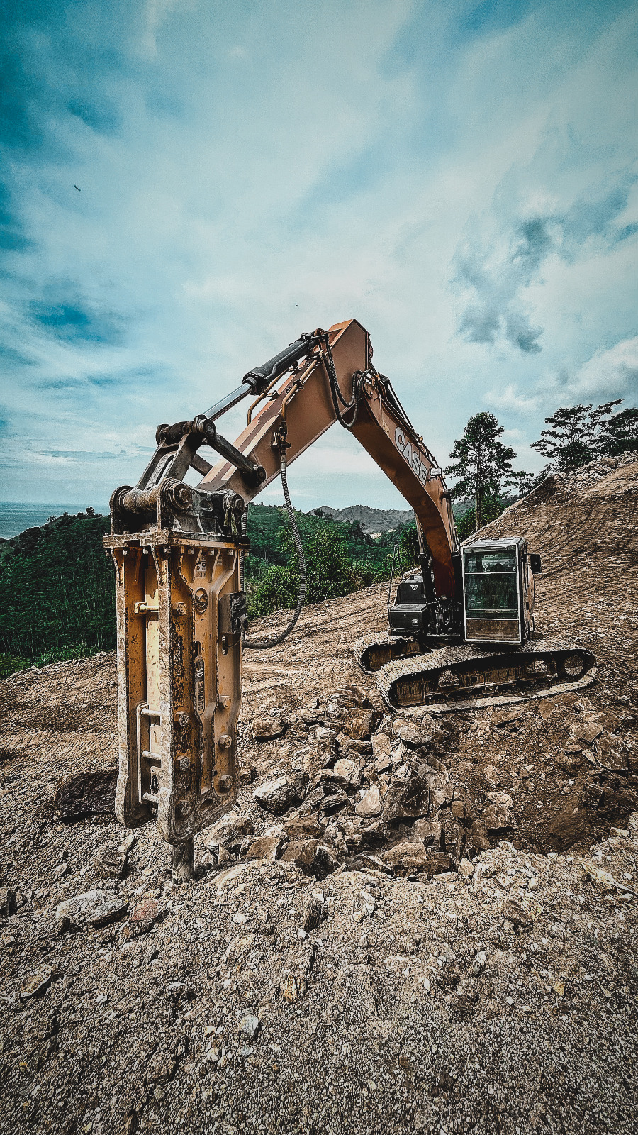 SANGDO hydraulic breaker installed on an excavator at a construction site